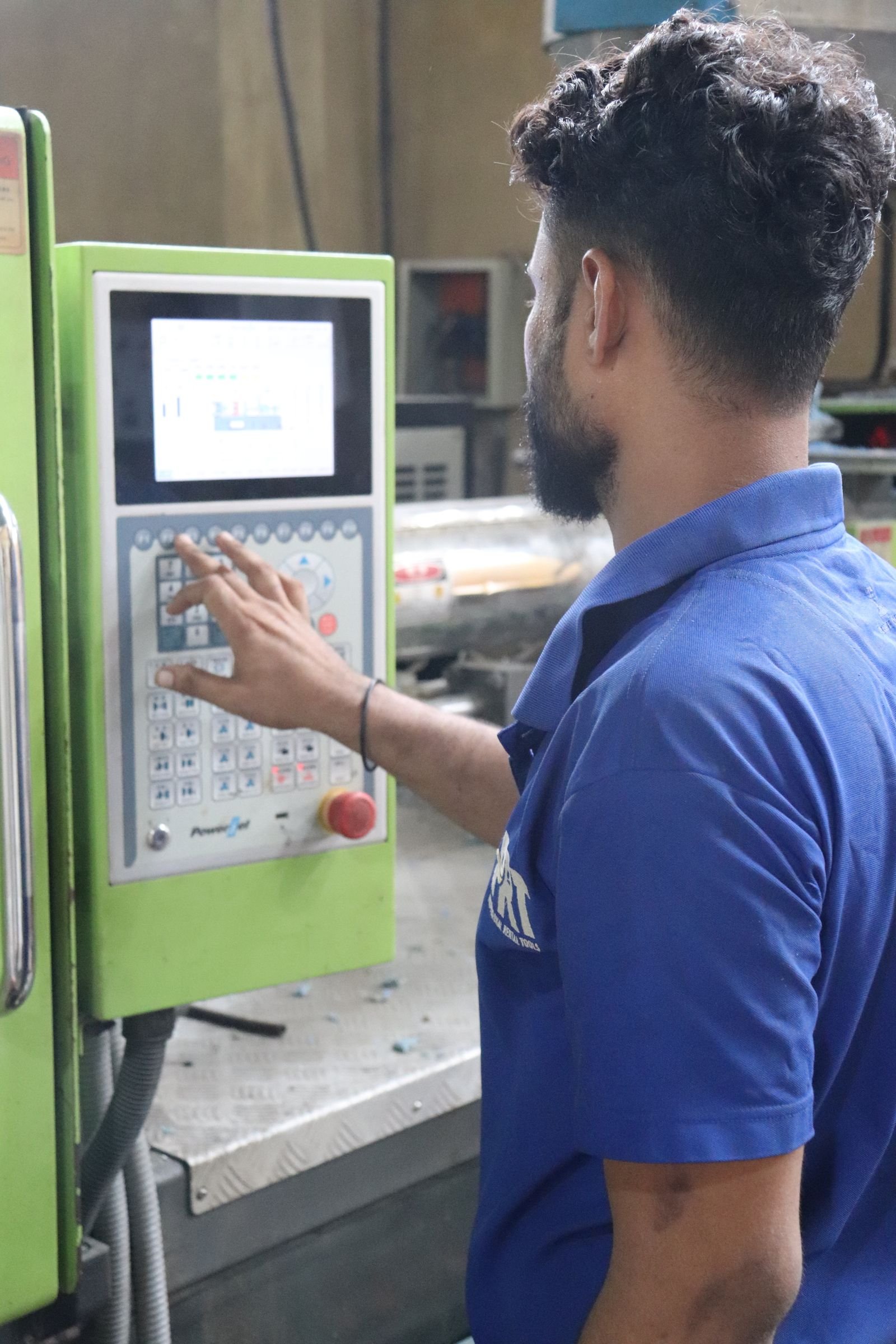 Technician reviewing manufacturing analytics on a control screen