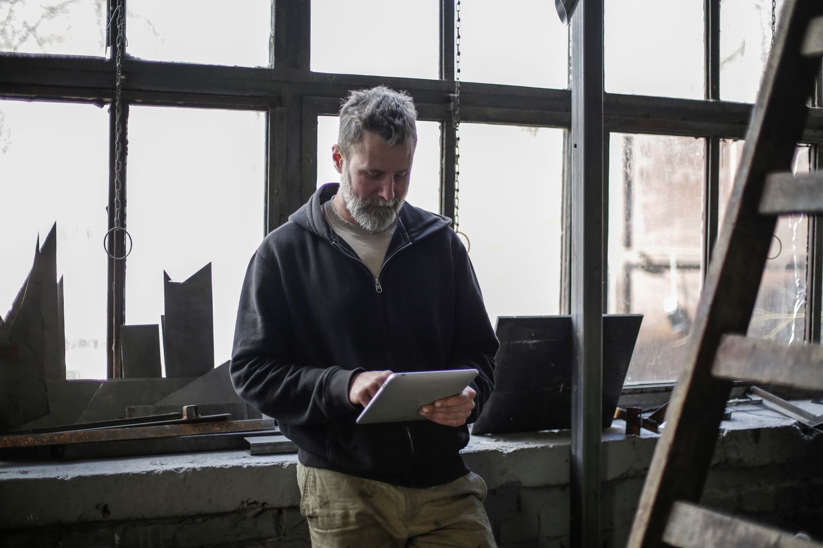 Engineer checking plant status on a tablet in a workshop
