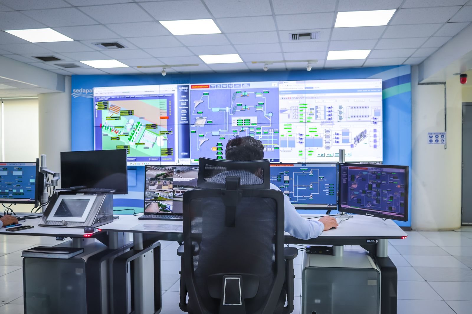 SCADA control room with operator monitoring plant displays