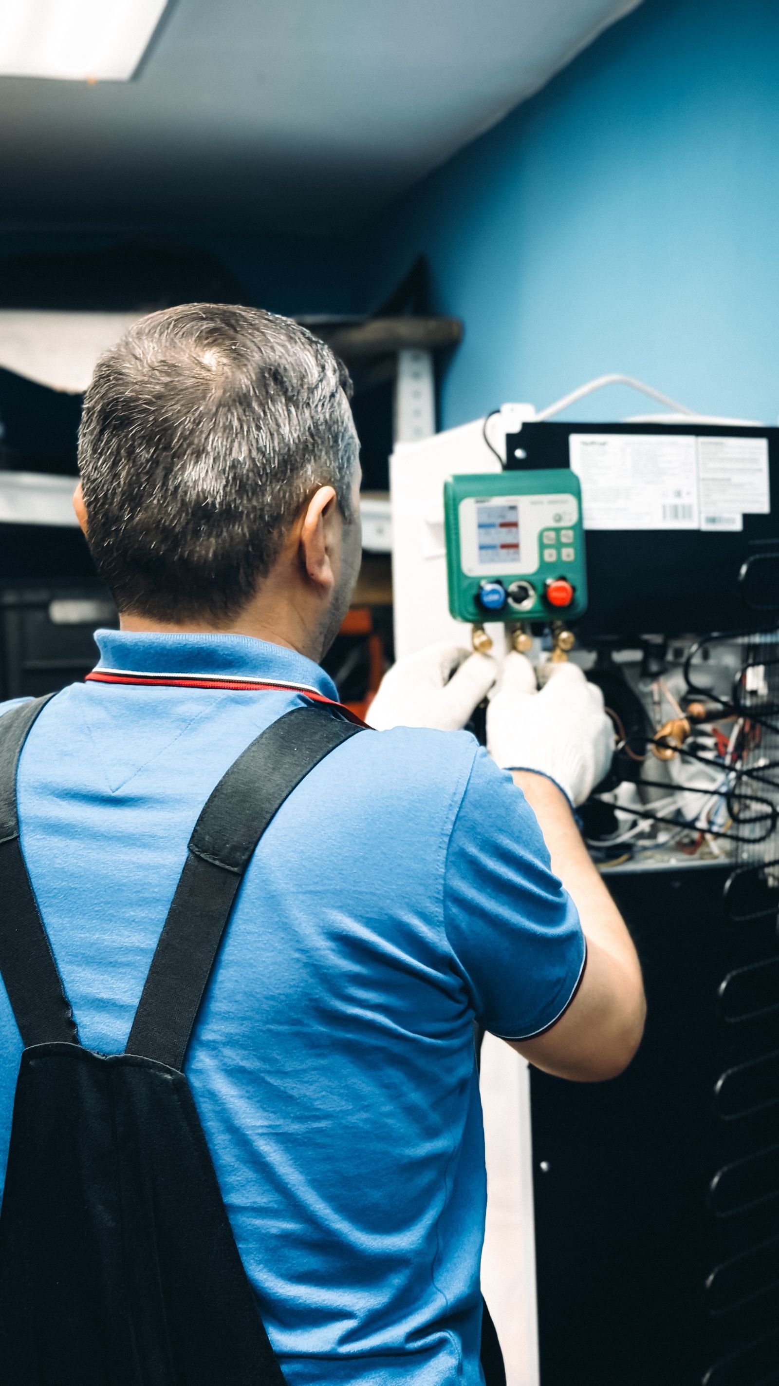 Technician performing refrigerant maintenance service